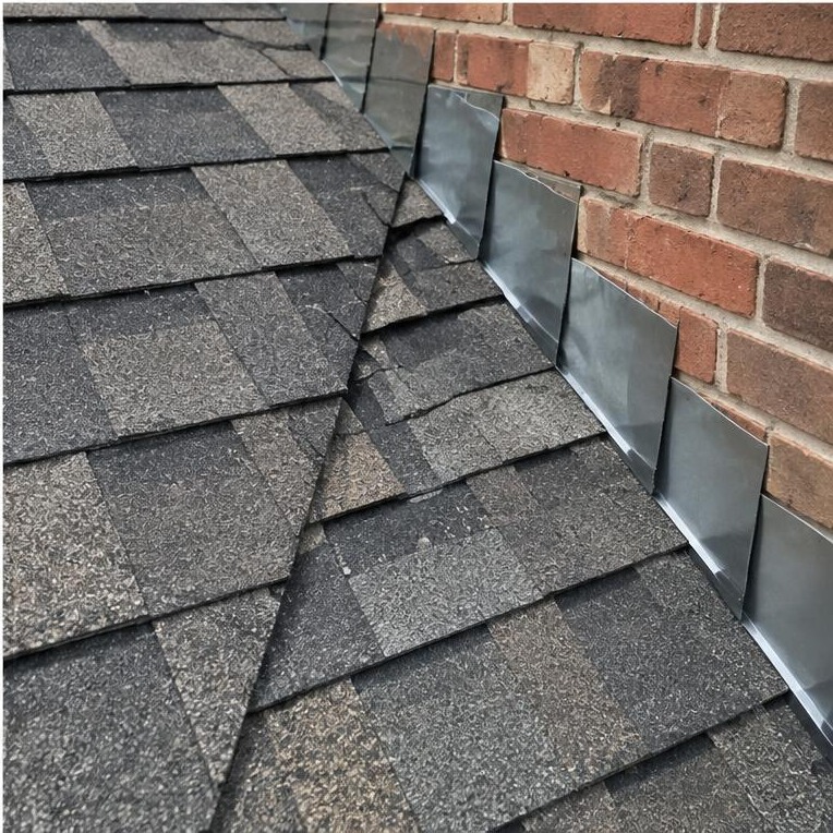 Shingle step flashing where a roof meets a brick wall
