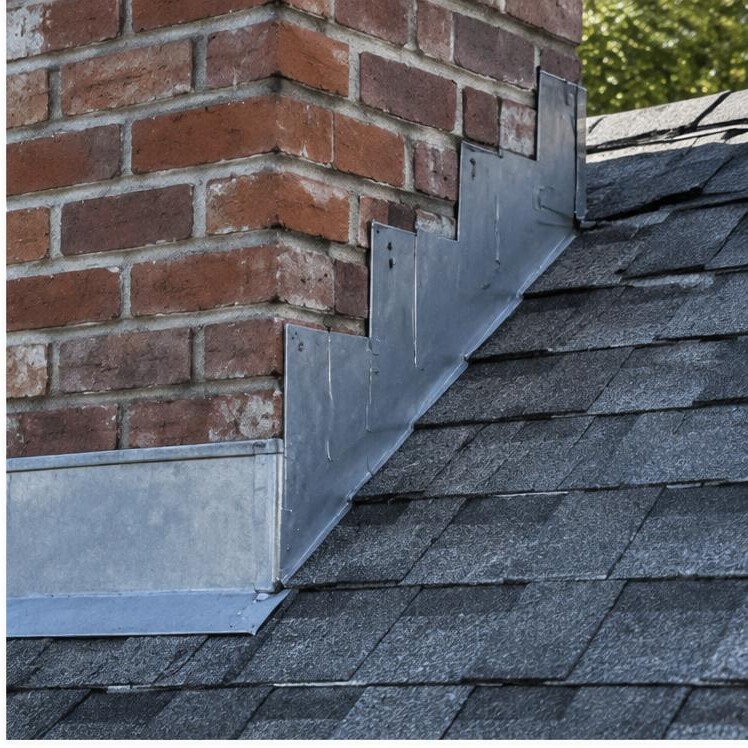 Step flashing installed along a brick chimney